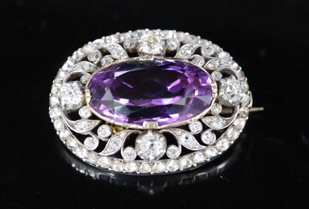 A Victorian gold and silver, diamond and amethyst set oval brooch, with safety chain,